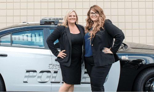 Kasey Castillo and Brandi Harper by patrol car